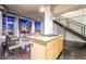 Kitchen island with light wood cabinets, granite countertop, and gas cooktop, adjacent to the living area at 360 E Desert Inn Rd # 807, Las Vegas, NV 89109