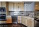Kitchen details including stainless steel appliances, granite countertops, wine fridge, and light wood cabinetry at 360 E Desert Inn Rd # 807, Las Vegas, NV 89109