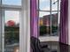 Living room featuring a door to the balcony, purple curtains, and city views including the Sphere at 360 E Desert Inn Rd # 807, Las Vegas, NV 89109