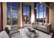 Bright living room with hardwood floors, floor-to-ceiling windows, and views of the Las Vegas strip at 360 E Desert Inn Rd # 807, Las Vegas, NV 89109