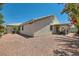 Home exterior showcasing a covered patio and low-maintenance gravel backyard at 3629 Ferrell St, North Las Vegas, NV 89032