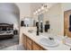 Bathroom with double sinks, decorative lighting, and access to the main bedroom at 3629 Ferrell St, North Las Vegas, NV 89032