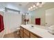 Bright bathroom featuring a large mirror, vanity, and a shower-tub combo at 3629 Ferrell St, North Las Vegas, NV 89032