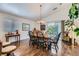 Well-lit dining room with hardwood floors, a chandelier, and access to the backyard at 3629 Ferrell St, North Las Vegas, NV 89032