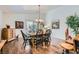 Well-lit dining room featuring hardwood floors, plenty of seating, and backyard access at 3629 Ferrell St, North Las Vegas, NV 89032