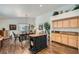 Bright kitchen and dining area with wood floors, center island, and custom cabinets at 3629 Ferrell St, North Las Vegas, NV 89032