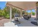 Covered patio area with outdoor seating, grill, and lush greenery at 3629 Ferrell St, North Las Vegas, NV 89032