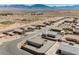 An aerial shot displays a peaceful desert neighborhood, showing cozy homes and scenic mountain backdrops at 37 Late Harvest Ave, Pahrump, NV 89060