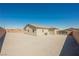 Desert landscape backyard with block wall and gated entry offering potential for customization at 37 Late Harvest Ave, Pahrump, NV 89060