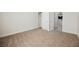 Carpeted bedroom featuring an open closet with white doors and access to other rooms in the home at 37 Late Harvest Ave, Pahrump, NV 89060
