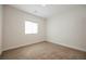 Bright bedroom with neutral carpet, crisp white trim and walls, and window bringing in natural light at 37 Late Harvest Ave, Pahrump, NV 89060