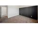 Bedroom with neutral carpet and a dark accent wall at 37 Late Harvest Ave, Pahrump, NV 89060