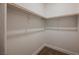 Walk-in closet with wood shelving and carpet floors at 37 Late Harvest Ave, Pahrump, NV 89060