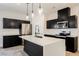 Modern kitchen featuring a white countertop island with stylish pendant lighting and stainless-steel appliances at 37 Late Harvest Ave, Pahrump, NV 89060