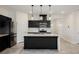 Modern kitchen featuring black cabinets, a white countertop island, and stainless-steel appliances at 37 Late Harvest Ave, Pahrump, NV 89060