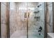 Modern tiled shower over tub with glass screen, and built in shampoo storage at 4036 E Ogden Ave, Las Vegas, NV 89110