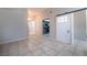 Bright living area with tile floors, open floor plan, and unique sliding barn door at 4036 E Ogden Ave, Las Vegas, NV 89110