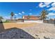 Spacious backyard showcasing desert landscaping, grassy areas, and a gated driveway at 4061 W Eldorado Ln, Las Vegas, NV 89139