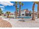 Lush backyard showcasing a sparkling pool, mature palms, and rock landscaping at 4061 W Eldorado Ln, Las Vegas, NV 89139