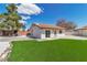 Beautiful backyard with lush lawn, rock landscaping, and mature trees for privacy at 4061 W Eldorado Ln, Las Vegas, NV 89139