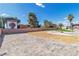 Oversized backyard with desert landscaping, artificial turf putting green, and gated storage area at 4061 W Eldorado Ln, Las Vegas, NV 89139