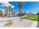 Stunning backyard featuring mature palms, a pool with a slide, and a putting green at 4061 W Eldorado Ln, Las Vegas, NV 89139