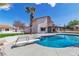 Lovely backyard with a swimming pool, diving board, and putting green for outdoor enjoyment at 4061 W Eldorado Ln, Las Vegas, NV 89139