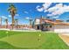 Beautiful backyard with a pool, slide, putting green, and an upstairs balcony at 4061 W Eldorado Ln, Las Vegas, NV 89139
