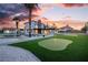 The backyard oasis features a pool, golf putting green, and ample space for outdoor activities and entertaining at 4061 W Eldorado Ln, Las Vegas, NV 89139