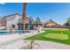An amazing backyard featuring a pool with a slide, putting green, and an upstairs balcony at 4061 W Eldorado Ln, Las Vegas, NV 89139