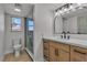 Updated bathroom with new vanity, framed mirror, shower and updated fixtures and plenty of natural light at 4061 W Eldorado Ln, Las Vegas, NV 89139