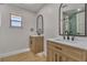 Modern bathroom featuring dual vanities with a wooden base and a shower at 4061 W Eldorado Ln, Las Vegas, NV 89139