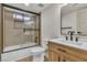 Modern bathroom showcasing a shower over tub, black hardware, and vanity at 4061 W Eldorado Ln, Las Vegas, NV 89139