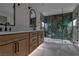 Modern bathroom showcasing a double vanity and luxurious glass-enclosed shower with beautiful stone at 4061 W Eldorado Ln, Las Vegas, NV 89139