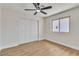 Cozy bedroom with wood floors, closet, a ceiling fan and natural light at 4061 W Eldorado Ln, Las Vegas, NV 89139