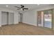 Bright primary bedroom with wood floors, ceiling fan, closet and sliding door to the backyard at 4061 W Eldorado Ln, Las Vegas, NV 89139