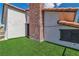 Exterior view of house with brick chimney and artificial turf at 4061 W Eldorado Ln, Las Vegas, NV 89139