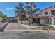 Inviting home exterior with gated driveway, decorative rock landscaping, and fresh flowers at 4061 W Eldorado Ln, Las Vegas, NV 89139