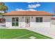 The home's front exterior with a new lawn and a well-maintained, decorative front door at 4061 W Eldorado Ln, Las Vegas, NV 89139