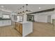 Open kitchen area with white and wood cabinets, a center island, and stainless steel appliances at 4061 W Eldorado Ln, Las Vegas, NV 89139