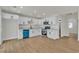 Kitchen area showcasing white cabinets, stainless steel appliances, and a wood floor at 4061 W Eldorado Ln, Las Vegas, NV 89139