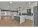 Spacious kitchen with a large center island, green backsplash, and stainless steel appliances at 4061 W Eldorado Ln, Las Vegas, NV 89139