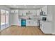 Bright kitchen featuring white cabinets and stainless steel appliances; sliding doors provide backyard access at 4061 W Eldorado Ln, Las Vegas, NV 89139
