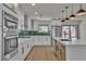 Modern kitchen boasts stainless steel appliances, white cabinets, and a large island with bar seating at 4061 W Eldorado Ln, Las Vegas, NV 89139