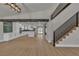 Open-concept living space with wood floors, stairs, and view into the modern kitchen at 4061 W Eldorado Ln, Las Vegas, NV 89139