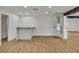 Modern, open floor plan with a bar area, wine storage, and wood-style flooring throughout at 4061 W Eldorado Ln, Las Vegas, NV 89139