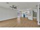 Open-concept living room featuring wood floors, ceiling fan, and sliding door to backyard at 4061 W Eldorado Ln, Las Vegas, NV 89139