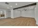 Spacious living room with wooden floors, beam, and recessed lighting at 4061 W Eldorado Ln, Las Vegas, NV 89139