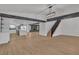 Spacious open-concept layout with hardwood floors, stairs, and a glimpse of the kitchen at 4061 W Eldorado Ln, Las Vegas, NV 89139