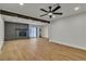 Bright open floor plan with brick fireplace, wood beam and ceiling fan at 4061 W Eldorado Ln, Las Vegas, NV 89139